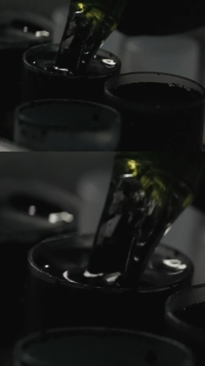 Tattoo needle being dipped into black ink